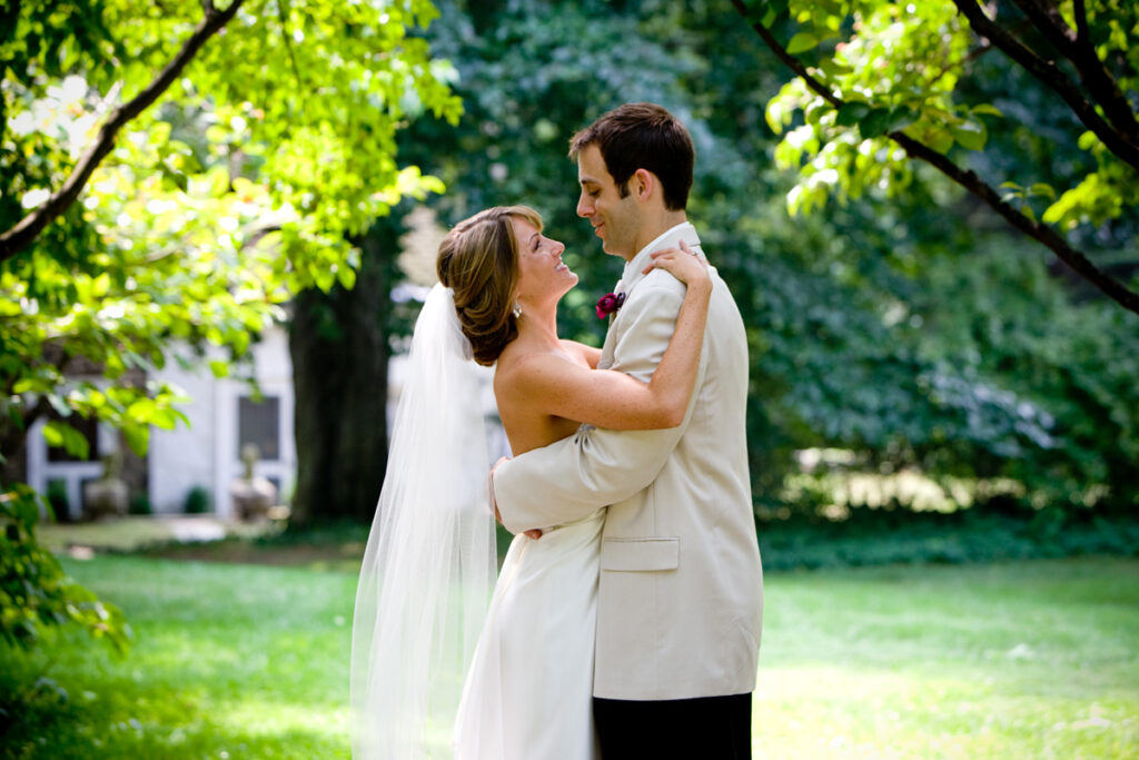 bride and groom looking at each other under the trees at Appleford Estate 