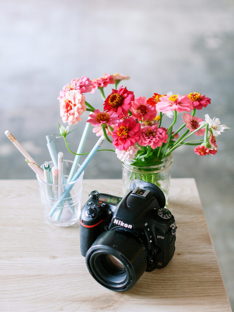 camera sitting on a desk inspiring Why It’s Time to Bring Back Blogging for Photographers