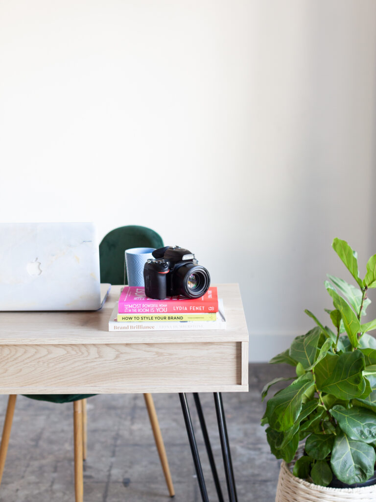 camera sitting on a desk inspiring Why It’s Time to Bring Back Blogging for Photographers